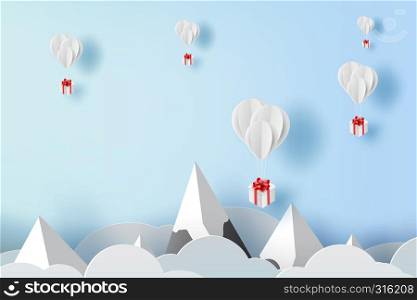 3D paper art and craft of balloon white floating on sky,Balloon with Gift Box Floating on air blue background,happy new years and merry Christmas,Festival concept,landscape snowy mountain.vector