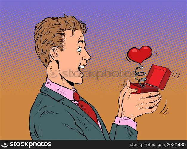 A businessman man looks at a red heart box valentine surprise greeting, love romance. Pop Art Retro Vector Illustration 50s 60s Vintage kitsch Style. A businessman man looks at a red heart box valentine surprise greeting, love romance