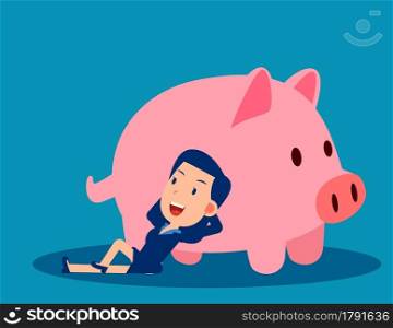 A businesswoman reclines close to the piggy bank. Saving money concept