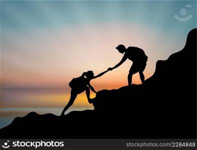 A couple of hikers helping each other climb a mountain