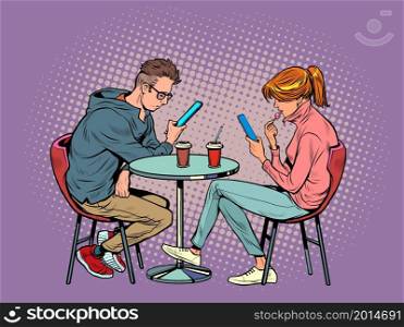 a couple on a date in a restaurant are looking at smartphones and not talking, loneliness and new technologies. Pop Art Retro Vector Illustration Kitsch Vintage 50s 60s Style. a couple on a date in a restaurant are looking at smartphones and not talking, loneliness and new technologies