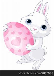 A cute Easter bunny holds brightly colored egg
