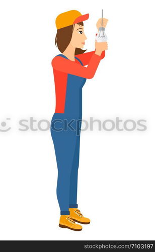 A female worker twisting a light bulb vector flat design illustration isolated on white background. Vertical layout.. Electrician twisting light bulb.