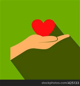 A hand giving a red heart flat icon on a green background. A hand giving a red heart flat icon