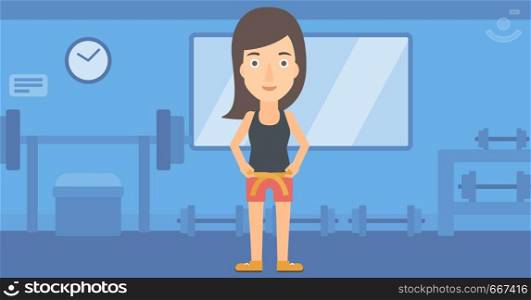 A happy woman measuring her waistline with a tape in the gym vector flat design illustration. Horizontal layout.. Woman measuring waist.