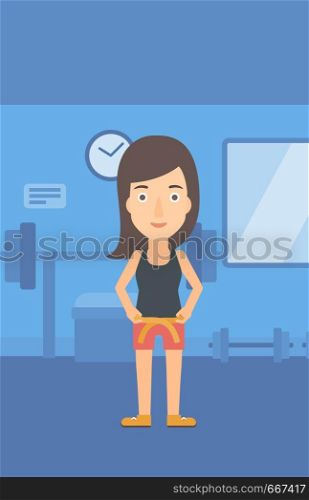 A happy woman measuring her waistline with a tape in the gym vector flat design illustration. Vertical layout.. Woman measuring waist.