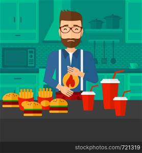 A hipster man with the beard standing in the kitchen in front of table full of junk food and suffering from heartburn vector flat design illustration. Square layout.. Man suffering from heartburn.