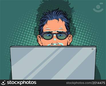 A man is looking at a laptop, the screen illuminates his face. Pop art Retro vector illustration 50e 60 style. A man is looking at a laptop, the screen illuminates his face