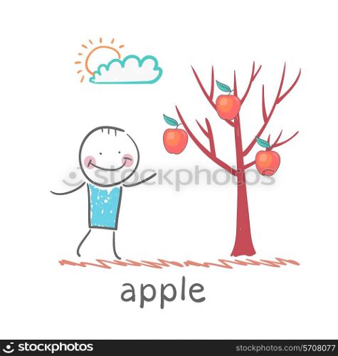 a man stands with a tree on which apples
