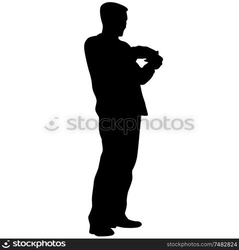 A man stands with his hands in front, silhouette on a white background.. A man stands with his hands in front, silhouette on a white background