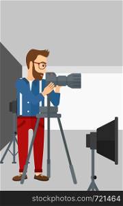 A photographer working with camera on the background of photo studio with lighting equipment vector flat design illustration. Vertical layout.. Photographer working with camera on a tripod.