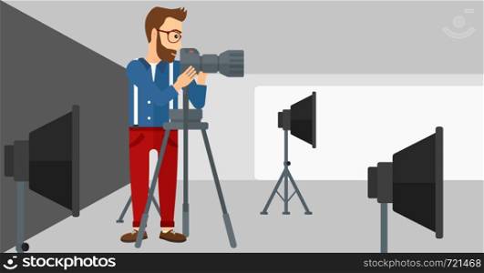 A photographer working with camera on the background of photo studio with lighting equipment vector flat design illustration. Horizontal layout.. Photographer working with camera on a tripod.