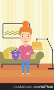A pregnant woman holding clothes for her baby on the background of living room vector flat design illustration. Vertical layout.. Pregnant woman with clothes for baby.