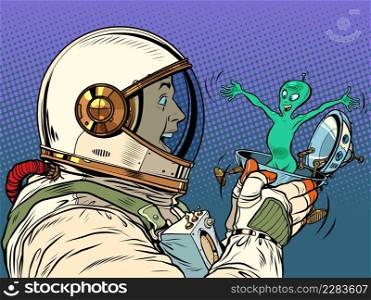 A surprised male astronaut looks at an alien in a festive UFO flying saucer box. Pop Art Retro Vector Illustration 50s 60s Vintage kitsch Style. A surprised male astronaut looks at an alien in a festive UFO flying saucer box