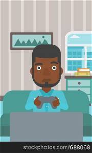 A tired african-american man sitting on a sofa with gamepad in hands on the background of living room vector flat design illustration. Vertical layout.. Addicted video gamer.