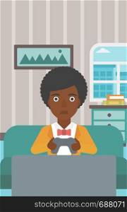A tired african-american woman sitting on a sofa with gamepad in hands on the background of living room vector flat design illustration. Vertical layout.. Addicted video gamer.