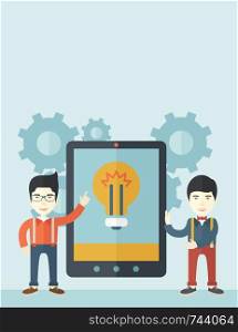 A two asian businessmen standing while holding a big screen tablet with bulb icon a computer tablet perspective view strategy marketing. Business concept. A Contemporary style with pastel palette, soft blue tinted background. Vector flat design illustration. Vertical layout with text space on top part.. Two businessmen holding big screen tablet.