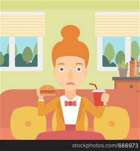 A woman sitting on a sofa while eating hamburger and drinking soda on the background of living room vector flat design illustration. Square layout.. Woman eating hamburger.