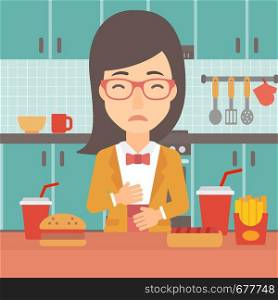 A woman standing in the kitchen in front of table full of junk food and suffering from heartburn vector flat design illustration. Square layout.. Woman suffering from heartburn.