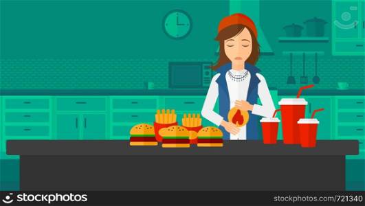 A woman standing in the kitchen in front of table full of junk food and suffering from heartburn vector flat design illustration. Horizontal layout.. Woman suffering from heartburn.