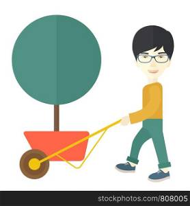 A young japanese man pushing the cart with green tree. Business growth concept. A Contemporary style. Vector flat design illustration isolated white background. Square layout. . Young man pushing the cart with tree.
