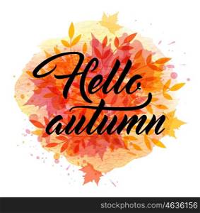 "Abstract autumn background with falling maple leaves. "Hello autumn" lettering and orange watercolor blots."