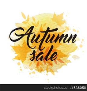 "Abstract autumn background with yellow falling maple leaves. "Autumn sale" lettering and yellow watercolor blots."
