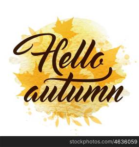 "Abstract autumn background with yellow falling maple leaves. "Hello autumn" lettering and yellow watercolor blots."