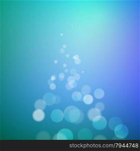 Abstract bokeh sparkles on blue blurred background