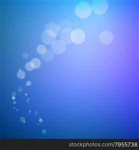 Abstract bokeh sparkles on blue blurred background