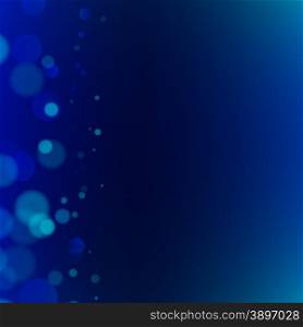Abstract bokeh sparkles on dark blue blurred background