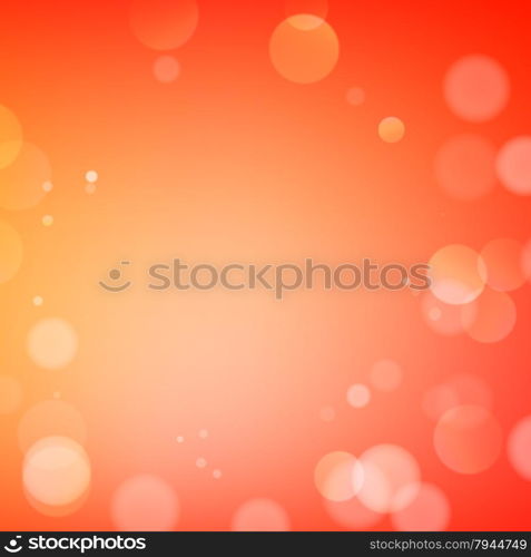 Abstract bokeh sparkles on orange blurred background