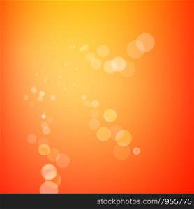 Abstract bokeh sparkles on orange blurred background