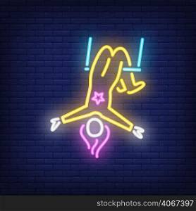 Aerial acrobat neon sign. Female circus gymnast on trapeze on dark brick wall background. Night bright advertisement. Vector illustration in neon style for performance poster or festival