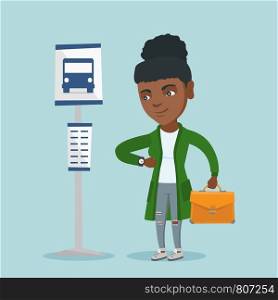African-american business woman waiting for a bus at the bus stop. Young business woman standing at the bus stop. Woman looking at her watch at the bus stop. Vector cartoon illustration. Square layout. African woman waiting for a bus at the bus stop.