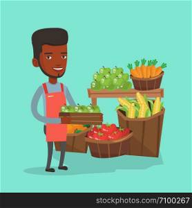 African-american worker of grocery store standing in front of section with vegetables and fruits. Worker of grocery store holding a box with apples. Vector flat design illustration. Square layout.. Supermarket worker with box full of apples.