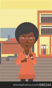 An african-american angry business woman standing in the office and pointing at her wrist watch. Vector flat design illustration. Vertical layout.. Angry business woman pointing at wrist watch.