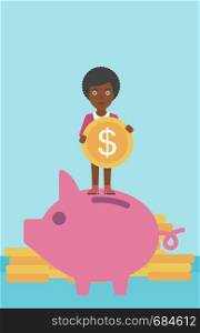 An african-american business woman saving her money by putting a coin in a big piggy bank on a background of stacks of gold coins. Vector flat design illustration. Vertical layout.. Business woman putting coin in piggy bank.