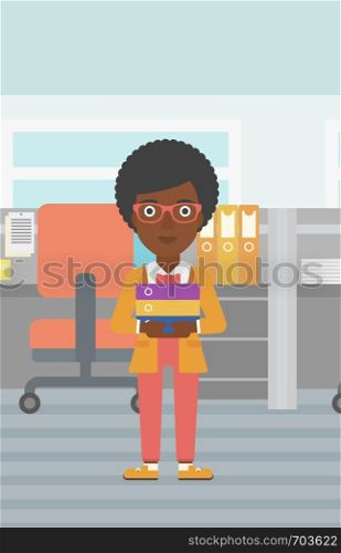 An african-american business woman standing with pile of folders in the office. Business woman carrying stack of folders. Vector flat design illustration. Vertical layout.. Business woman holding pile of folders.