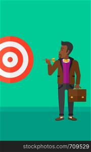An african-american businessman standing with arrow in hand and aiming at a target board on a green background vector flat design illustration. Vertical layout.. Businessman with target board.