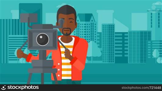 An african-american cameraman looking through movie camera on a city background vector flat design illustration. Horizontal layout.. Cameraman with movie camera on a tripod.