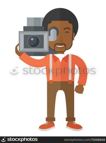 An african-american cameraman with video camera taking a video vector flat design illustration isolated on white background. Vertical layout.. Cameraman.