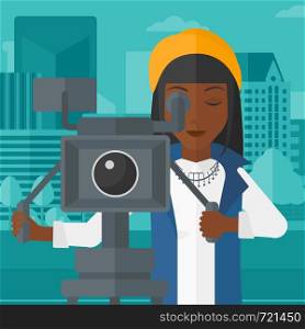 An african-american camerawoman looking through movie camera on a city background vector flat design illustration. Square layout.. Camerawoman with movie camera on a tripod.