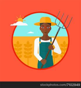 An african-american farmer standing with a pitchfork in wheat field. Woman holding agricultural tool and working in wheat field. Vector flat design illustration in the circle isolated on background.. Farmer with pitchfork in wheat field.
