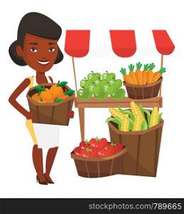 An african-american greengrocer holding basket with oranges. Greengrocer holding basket with fruits. Young happy greengrocer at work. Vector flat design illustration isolated on white background.. Greengrocer with fruits and vegetables.
