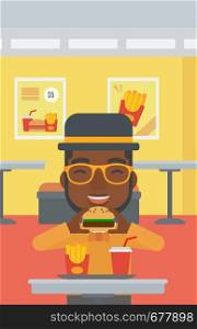 An african-american man eating hamburger on a cafe background vector flat design illustration. Vertical layout.. Man eating hamburger.