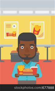An african-american man holding a tray full of junk food on a cafe background vector flat design illustration. Vertical layout.. Man with fast food.