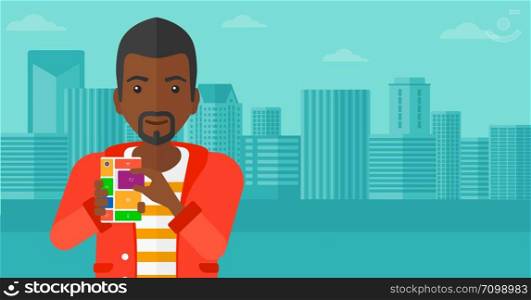 An african-american man holding modular phone on a city background vector flat design illustration. Horizontal layout.. Man with modular phone.