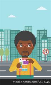 An african-american man holding modular phone. Young man with modular phone on a city background. Man using modular phone. Vector flat design illustration. Vertical layout.. Man with modular phone vector illustration.