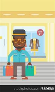 An african-american man holding shopping bags on the background of boutique window with dressed mannequins. Happy young man carrying shopping bags. Vector flat design illustration. Vertical layout.. Happy man with shopping bags vector illustration.
